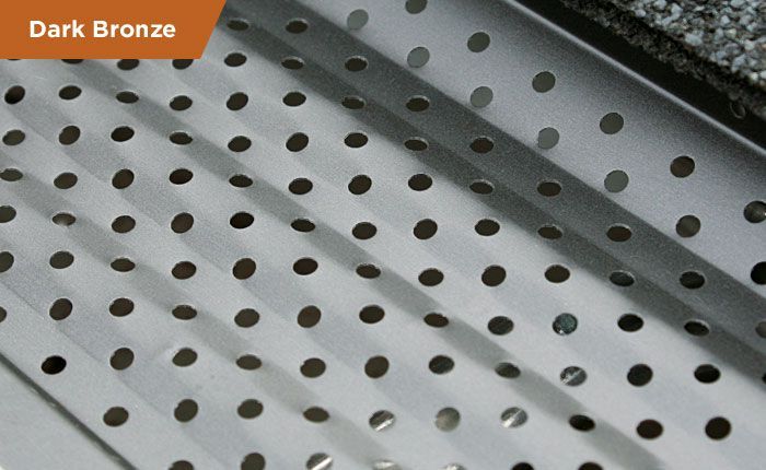 A dark bronze metal item with holes in it